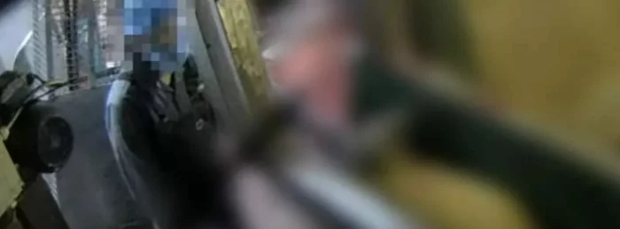 Man kills a lamb in a slaugterhouse